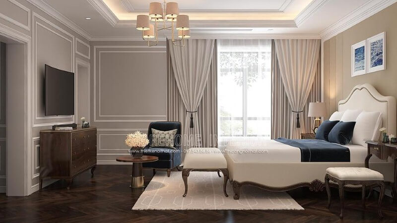 Giường bọc nệm trắng kết hợp sắc trầm từ ghế, đôn sofa, kệ tivi gỗ óc chó đã tạo nên bức tranh hài hòa, đẹp, sang trọng trong phòng ngủ master tân cổ điển. thiết kế nội thất chung cư